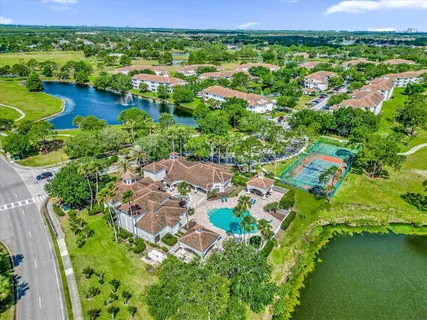 an aerial view of residential houses with outdoor space and lake view
