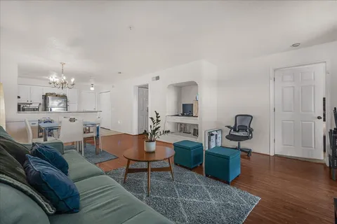 a living room with furniture and a wooden floor