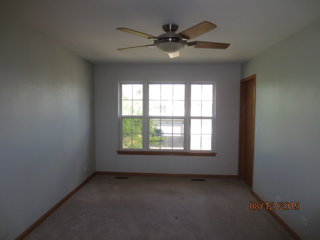 10549 Wakefield Lane Huntley, IL 60142 - Photo 12 of 19 an empty room with a window and a fan