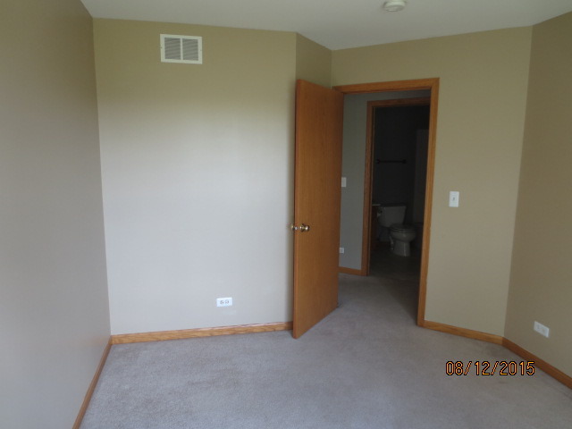 10549 Wakefield Lane Huntley, IL 60142 - Photo 18 of 19 an empty room that has a grey walls