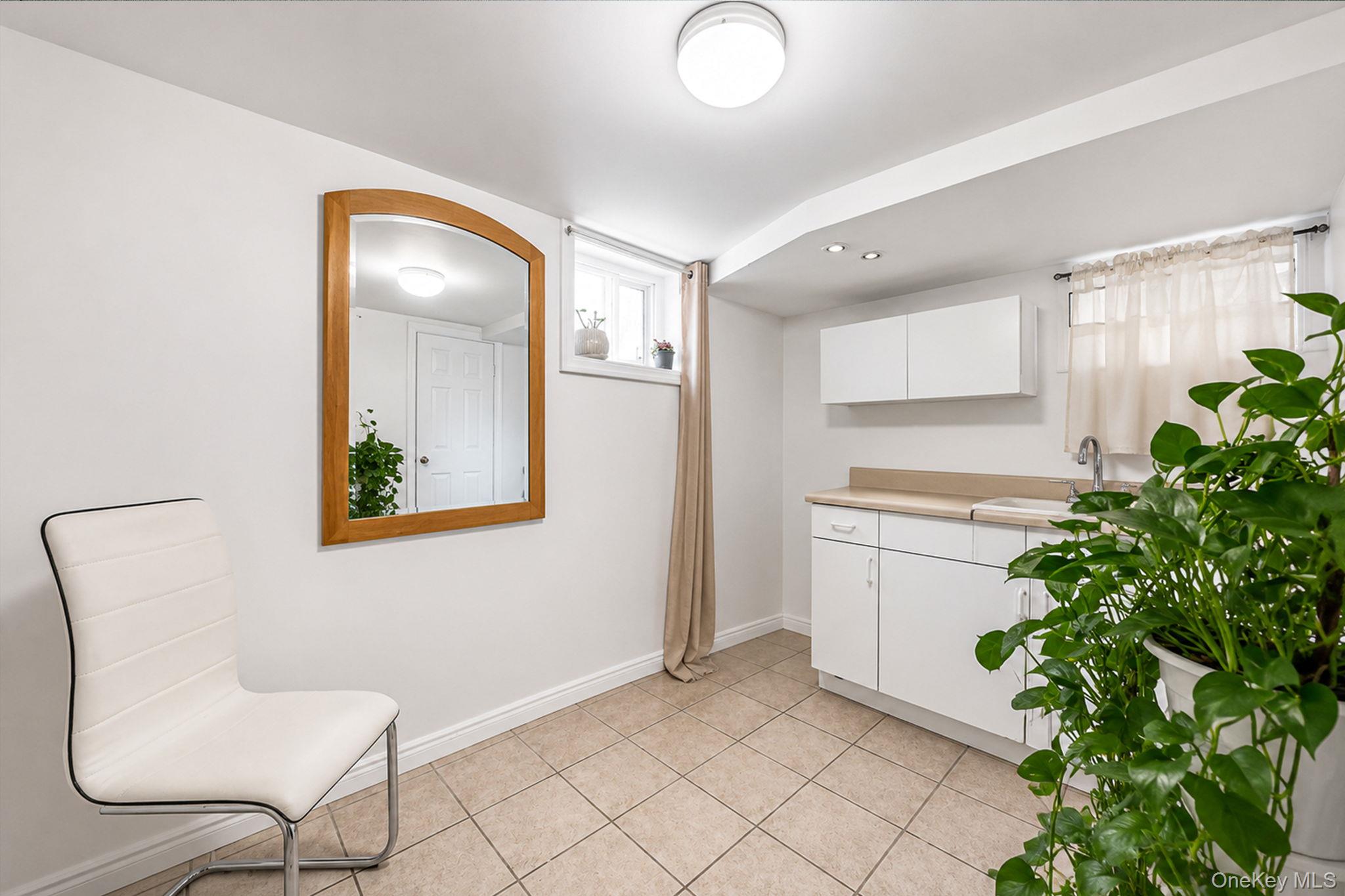 93-20 92nd Avenue Queens, NY 11421 - Photo 18 of 21 a hallway with painting and a potted plant