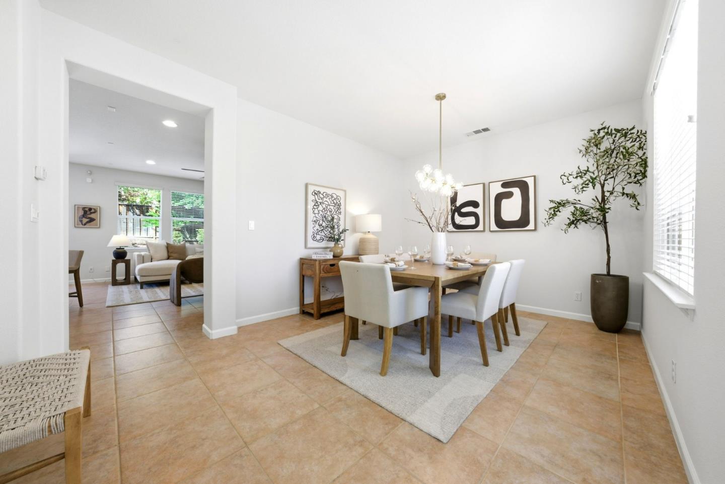 2556 Harlow Lane San Ramon, CA 94582 - Photo 7 of 62 a view of a dining room and livingroom with furniture wooden floor a rug a potted plant and a chandelier