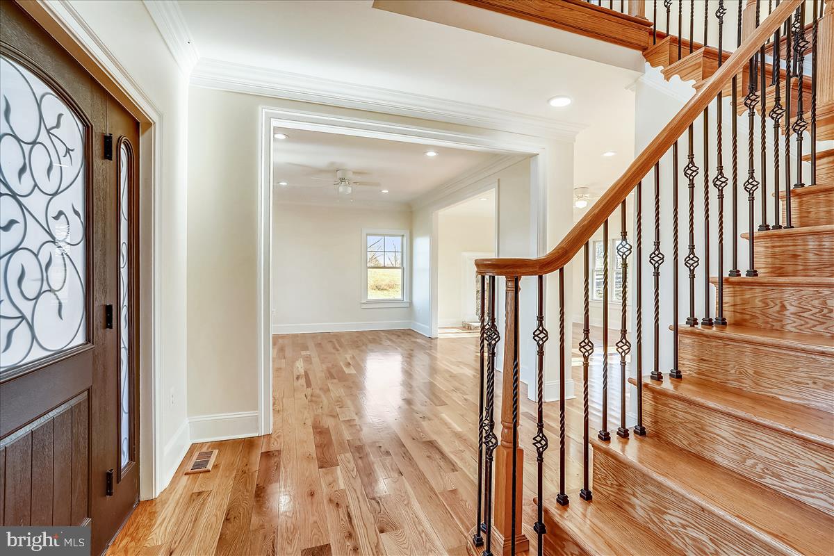 Foyer opens to living, dining, kitchen and den