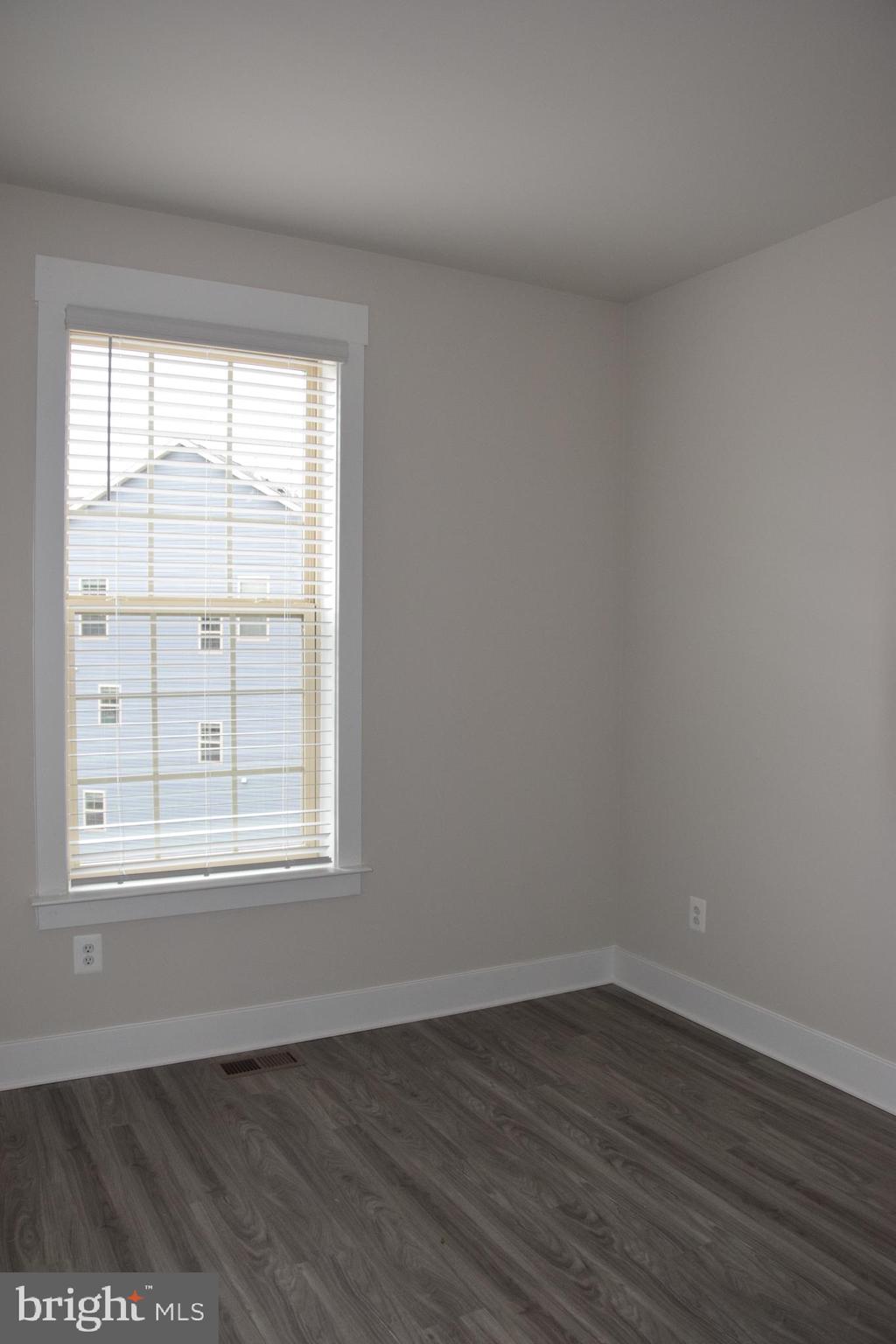 2915 Osprey Way Frederick, MD 21701 - Photo 12 of 27 an empty room with wooden floor and windows