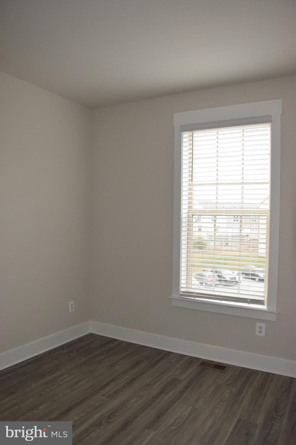 2915 Osprey Way Frederick, MD 21701 - Photo 13 of 27 a view of an empty room with wooden floor and a window
