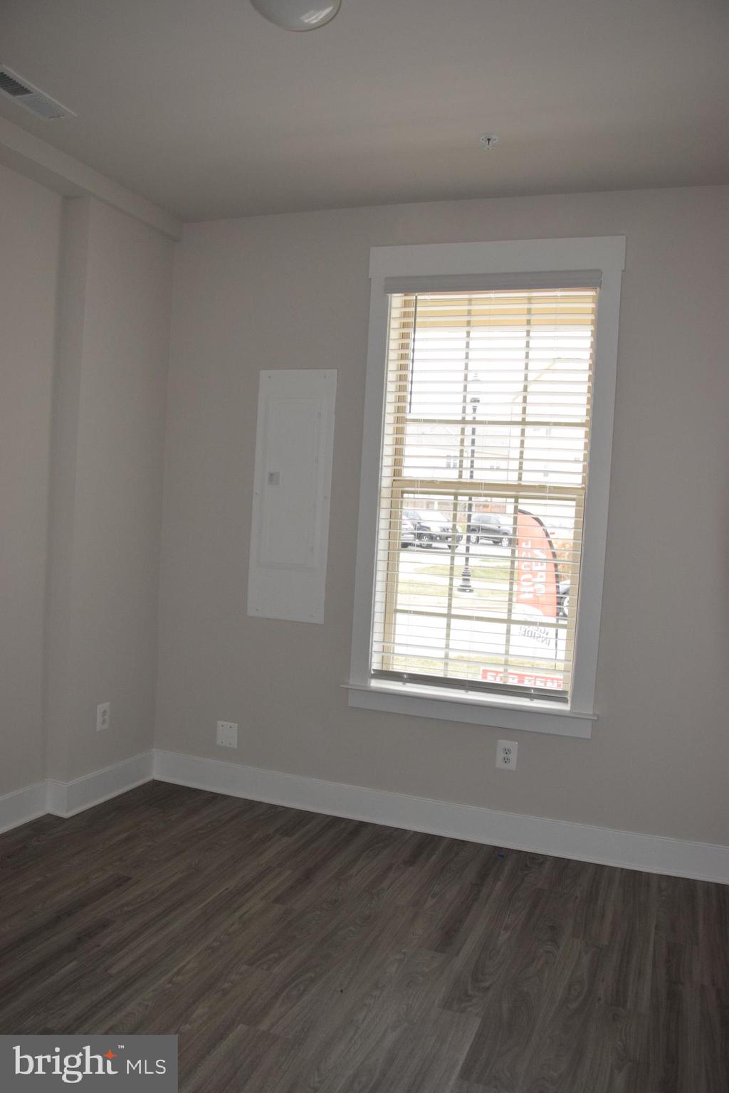 2915 Osprey Way Frederick, MD 21701 - Photo 18 of 27 an empty room with wooden floor and windows