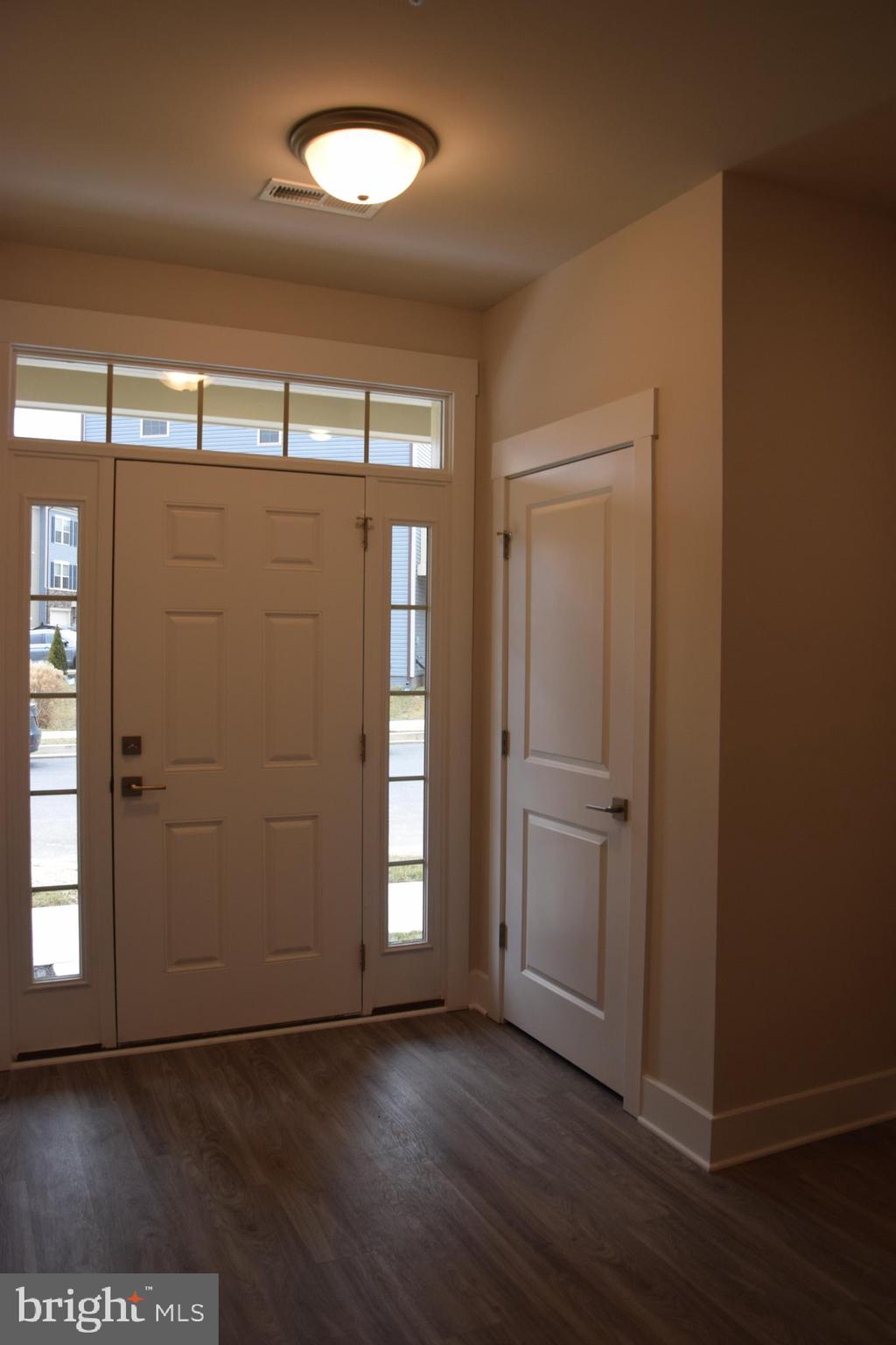 2915 Osprey Way Frederick, MD 21701 - Photo 2 of 27 an empty room with wooden floor and windows