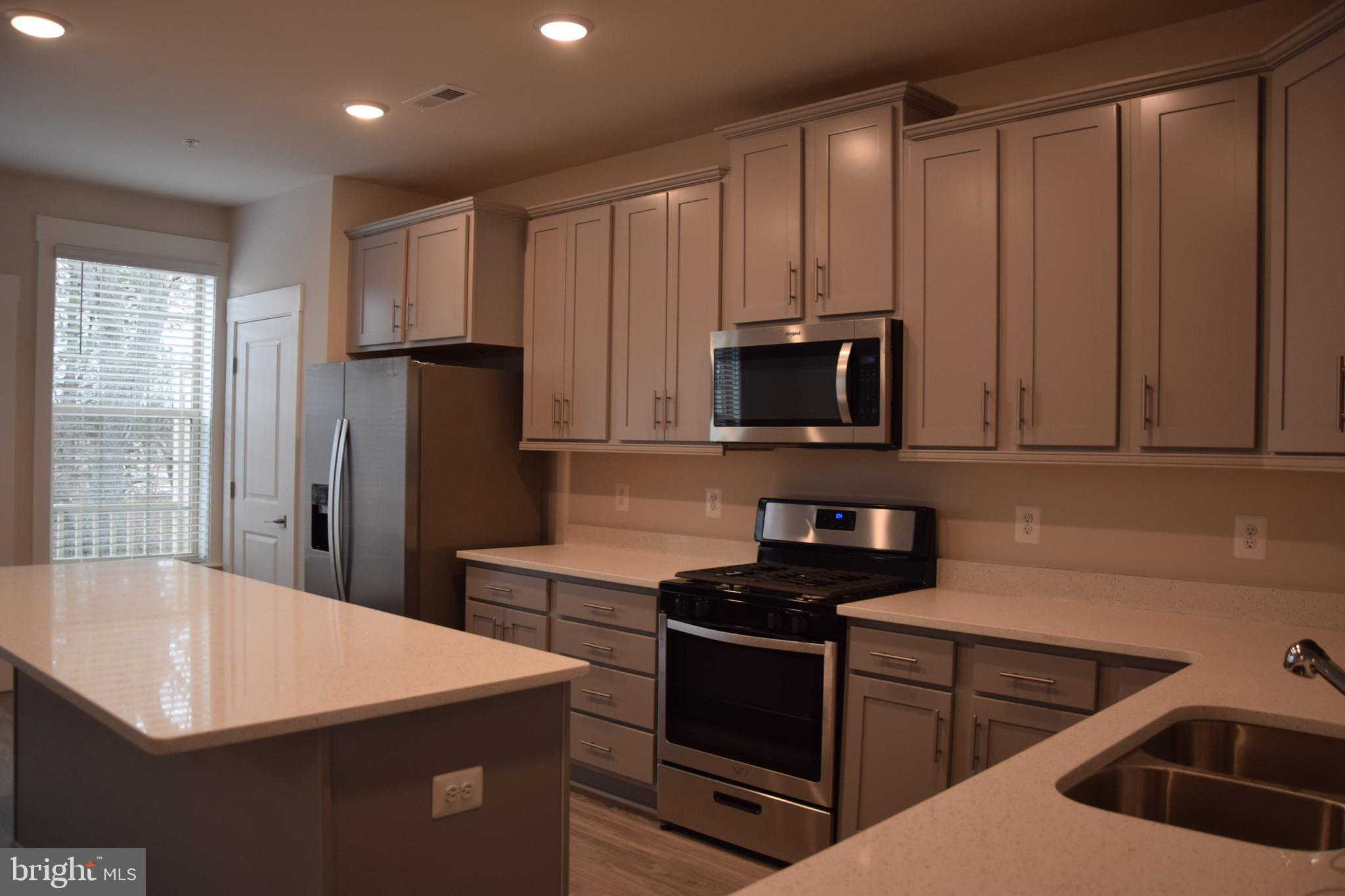 2915 Osprey Way Frederick, MD 21701 - Photo 4 of 27 a kitchen that has a sink and a stove top oven