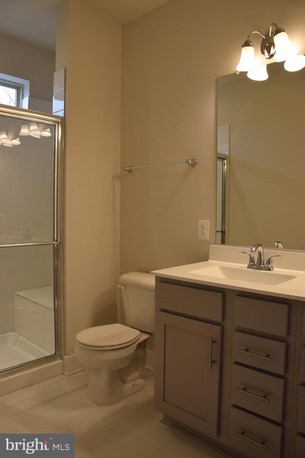 2915 Osprey Way Frederick, MD 21701 - Photo 9 of 27 a bathroom with a toilet a sink and mirror