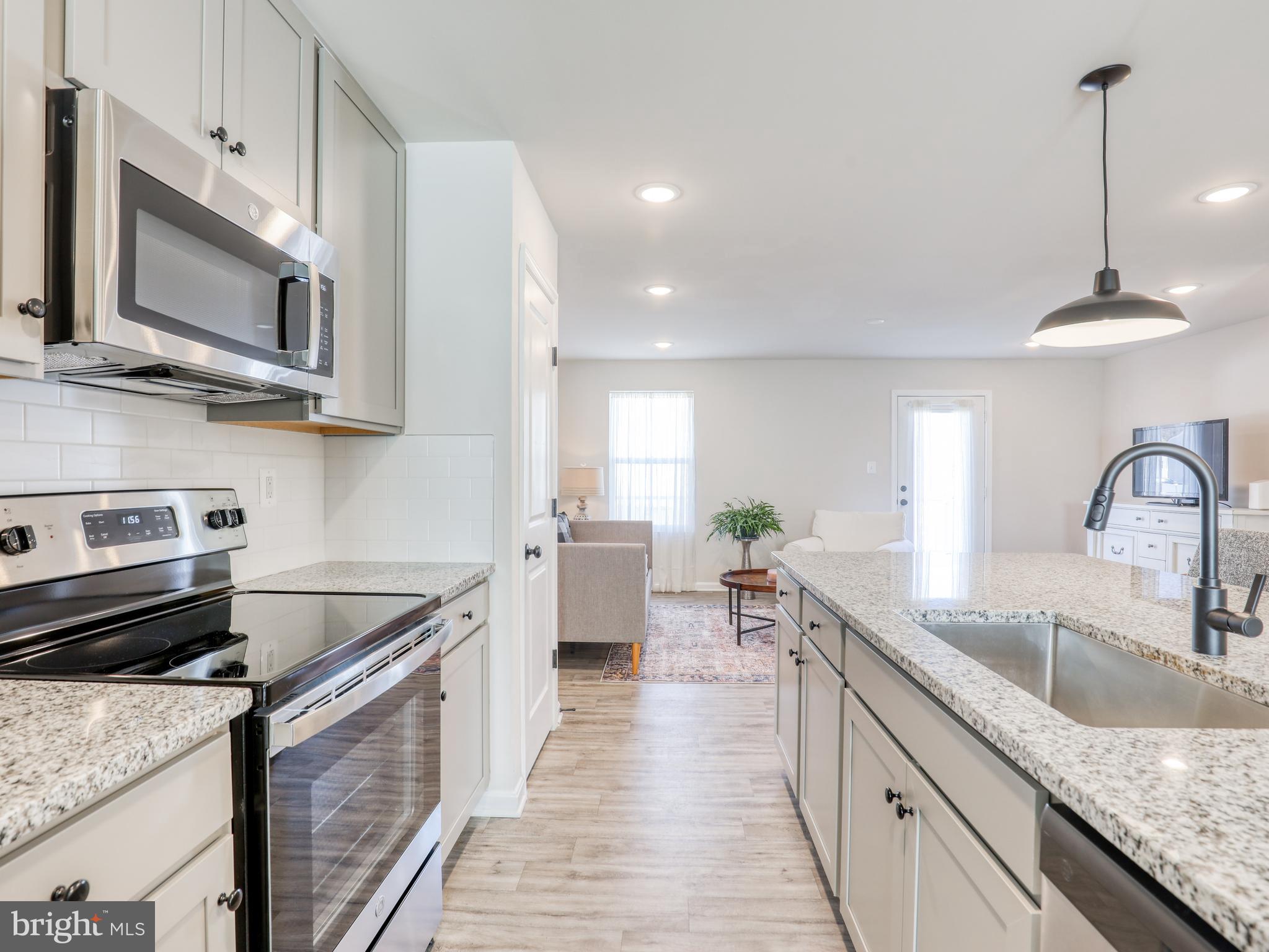 58 Thrower Road Hedgesville, WV 25427 - Photo 21 of 42 a kitchen with stainless steel appliances granite countertop a sink stove and microwave
