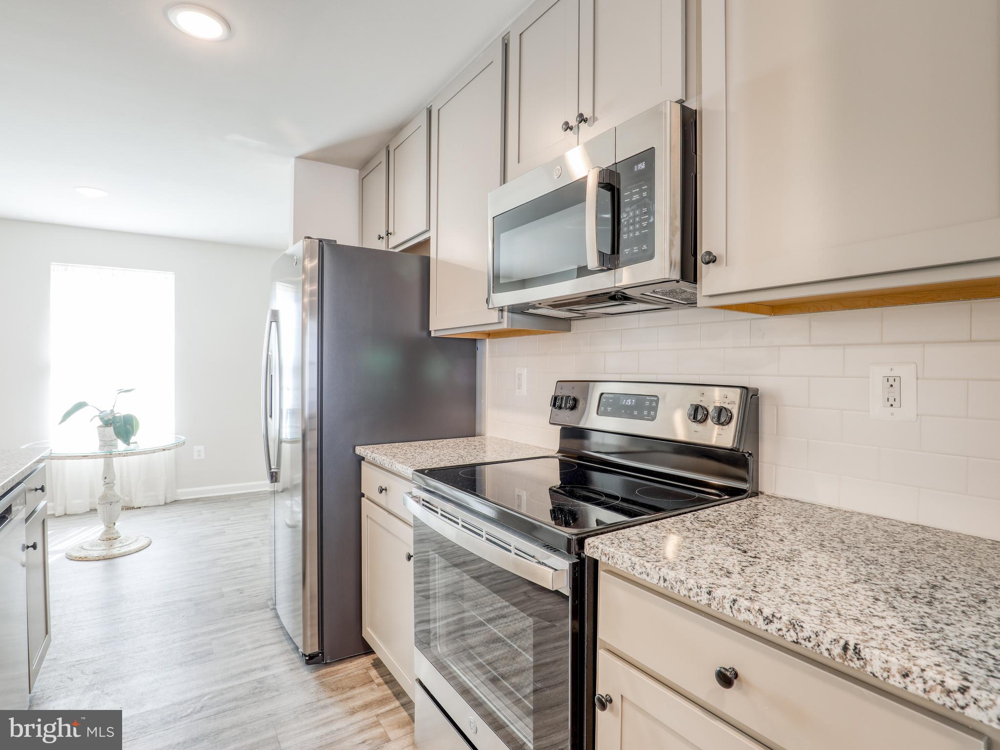 58 Thrower Road Hedgesville, WV 25427 - Photo 22 of 42 a kitchen with stainless steel appliances granite countertop a stove microwave and refrigerator