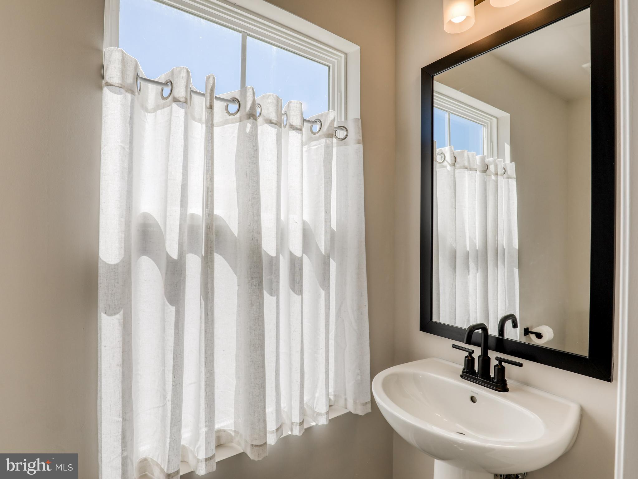 58 Thrower Road Hedgesville, WV 25427 - Photo 24 of 42 a bathroom with a sink a mirror and a window