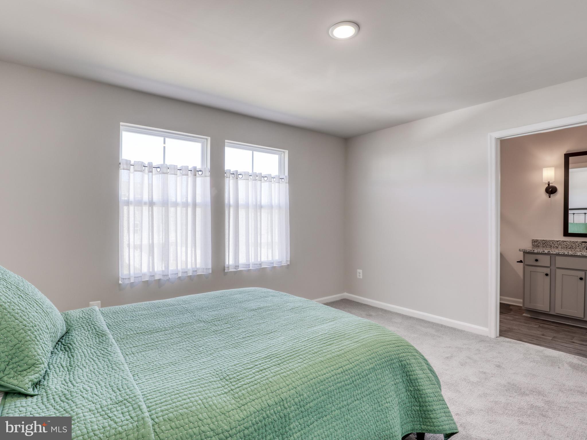 58 Thrower Road Hedgesville, WV 25427 - Photo 27 of 42 a spacious bedroom with a bed and a window