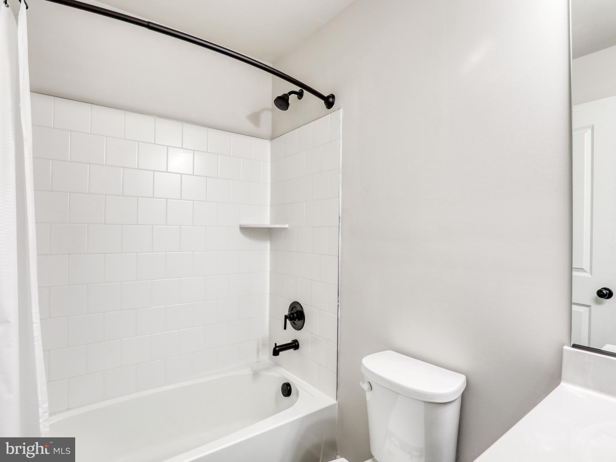 58 Thrower Road Hedgesville, WV 25427 - Photo 34 of 42 a white toilet sitting next to a bath tub