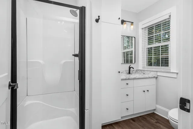 a bathroom with a toilet a sink and a window