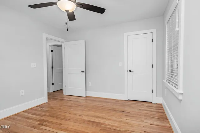 a view of a room with wooden floor and a window