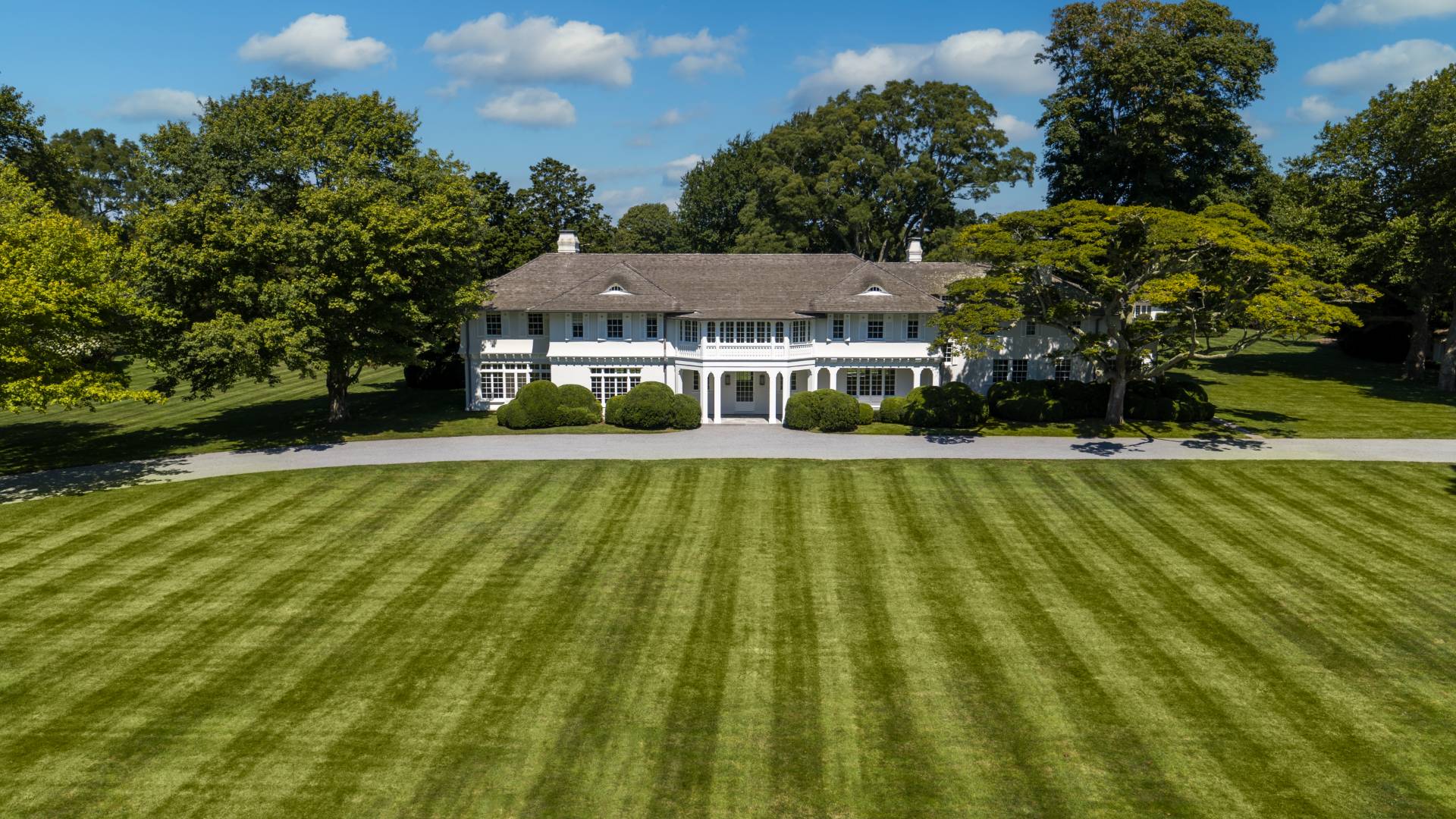 a view of house that has a swimming pool with a yard