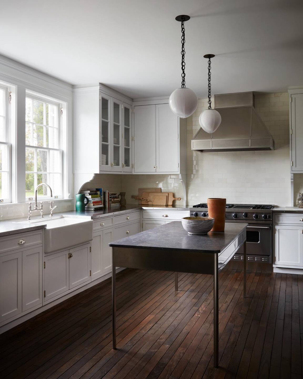 121 Further Lane East Hampton, NY 11937 - Photo 19 of 23 a kitchen with a table chairs stove and cabinets