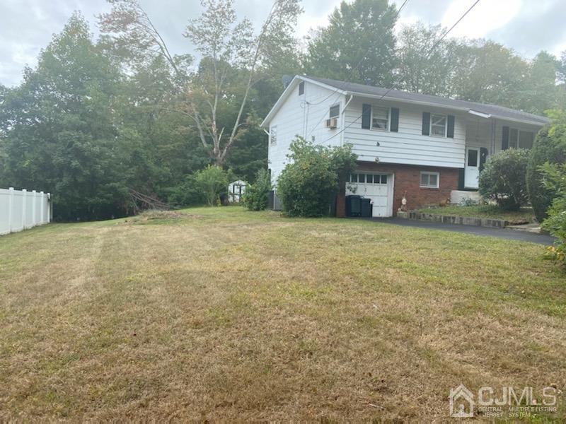4 Holiday Road Manalapan, NJ 07726 - Photo 3 of 9 a front view of a house with a yard