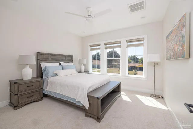 a bedroom with a large bed and a window