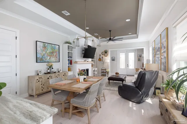 a living room with furniture a large window and a flat screen tv