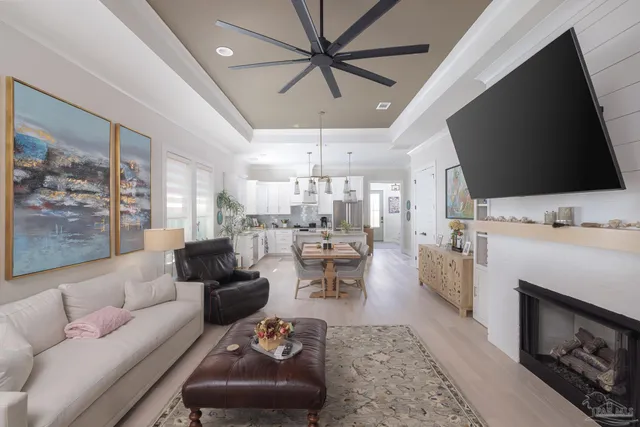 a living room with furniture a flat screen tv and a fireplace