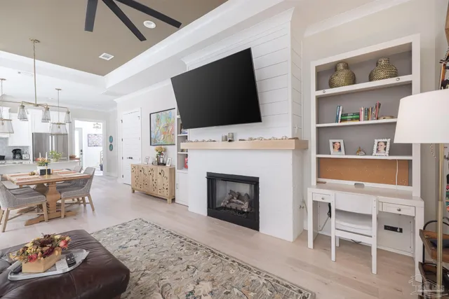 a living room with furniture fireplace and flat screen tv