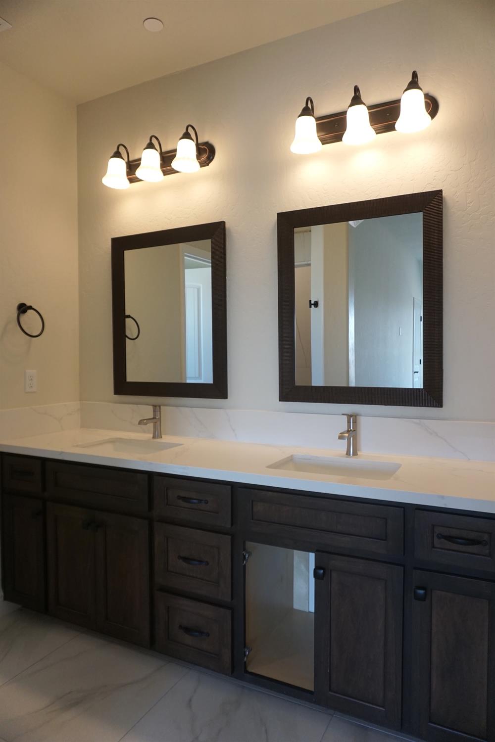 16398 Road 37 Madera, CA 93636 - Photo 11 of 23 a bathroom with double vanity sinks and a mirror