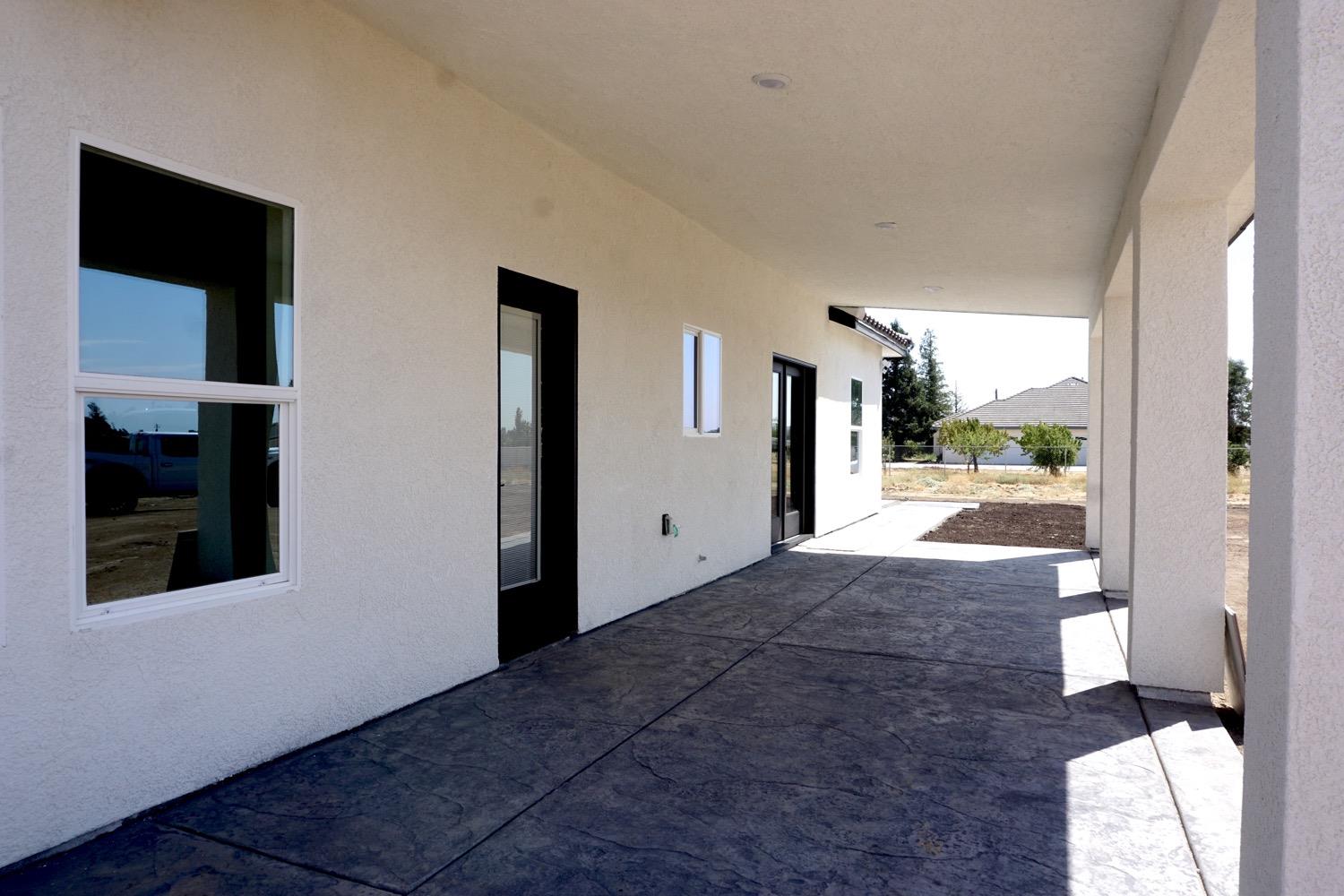 16398 Road 37 Madera, CA 93636 - Photo 19 of 23 a view of a hallway with wooden floor and a large window