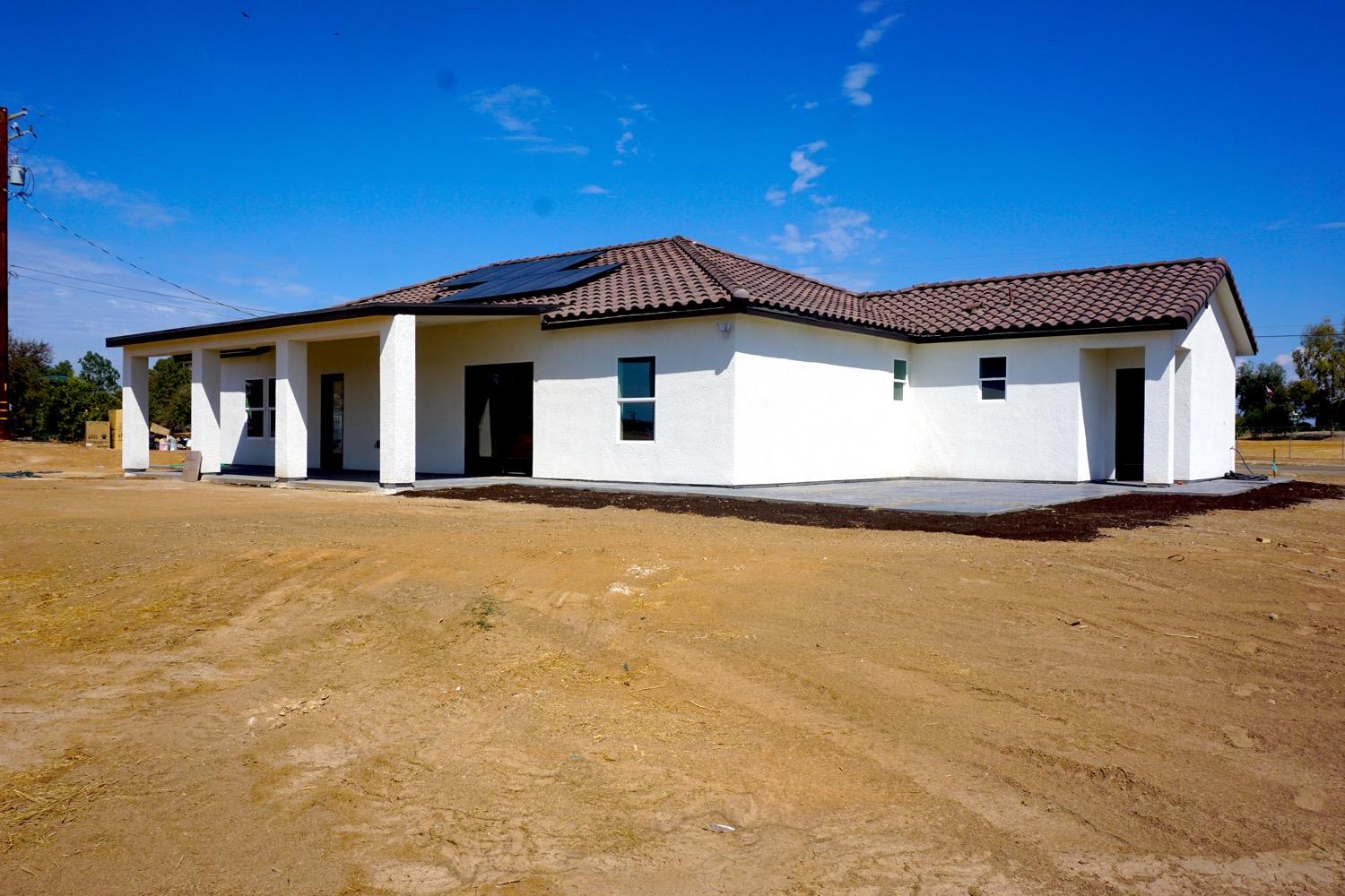 16398 Road 37 Madera, CA 93636 - Photo 20 of 23 a front view of house with yard and trees in the background