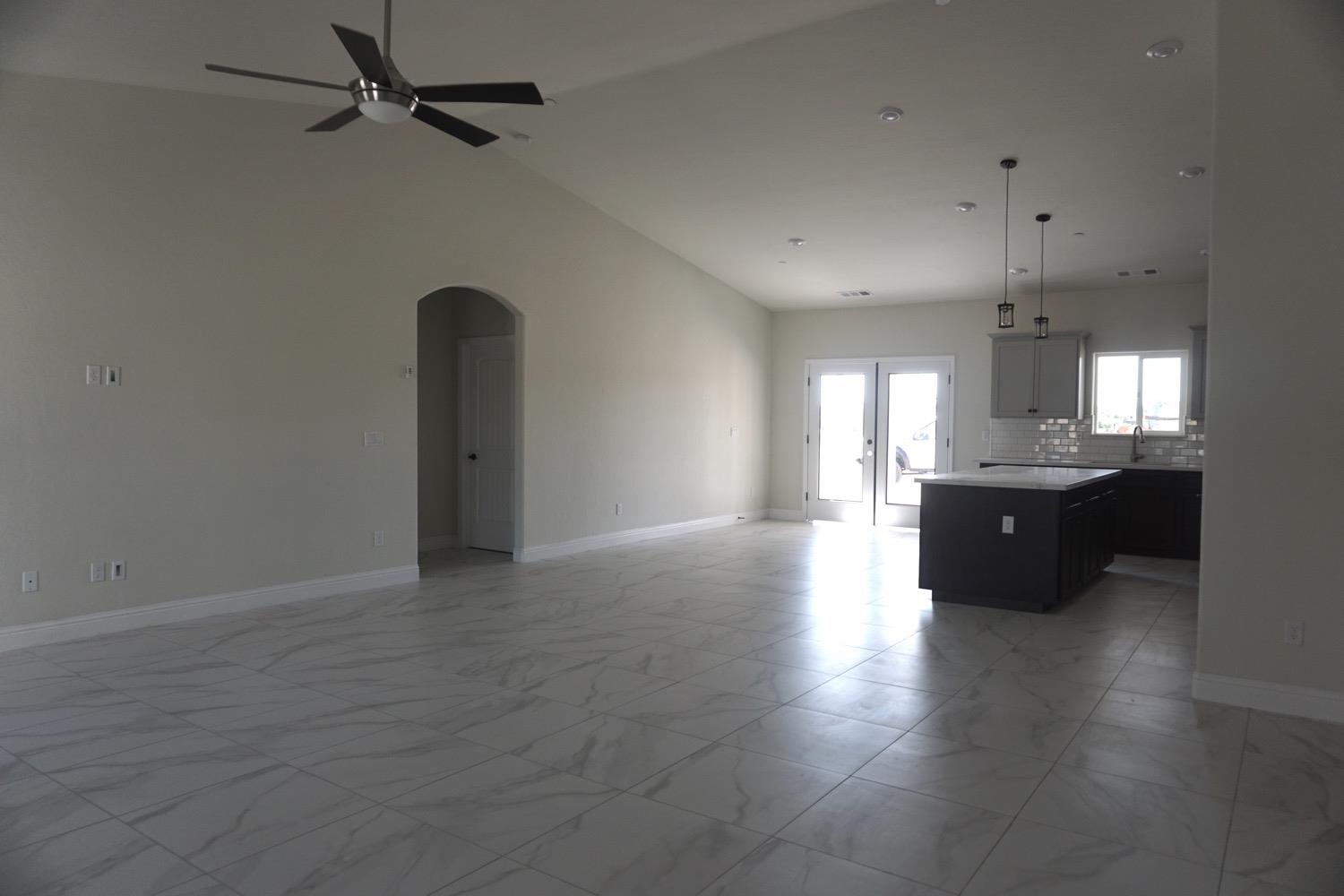 16398 Road 37 Madera, CA 93636 - Photo 3 of 23 an empty room with wooden floor and windows