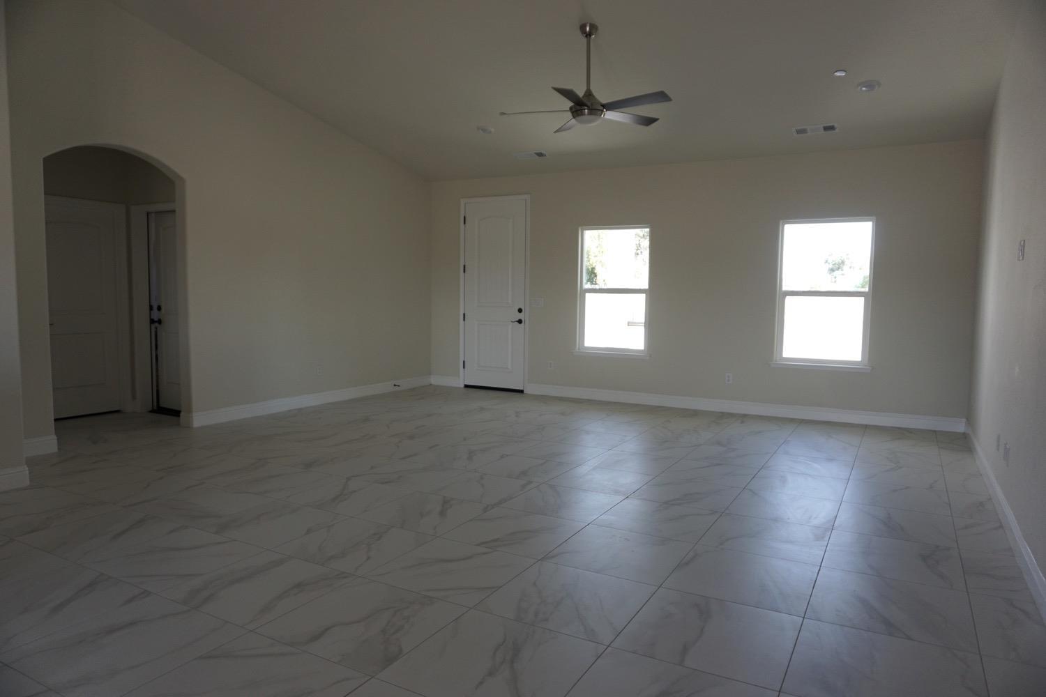 16398 Road 37 Madera, CA 93636 - Photo 4 of 23 an empty room with wooden floor chandelier and windows