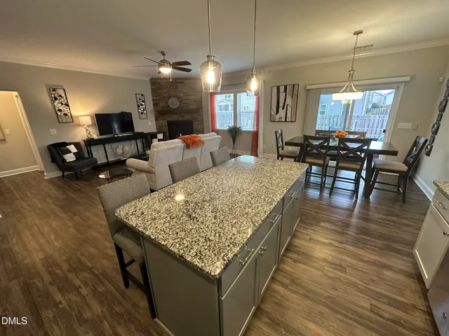a living room with dining table and a wooden floor