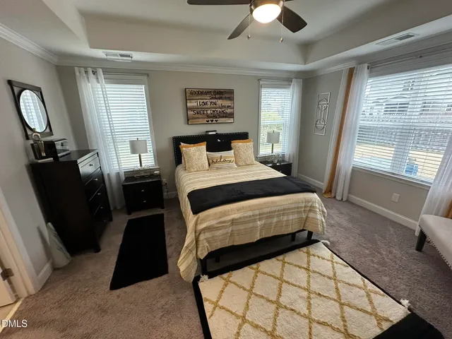 a bedroom with a bed and a large mirror