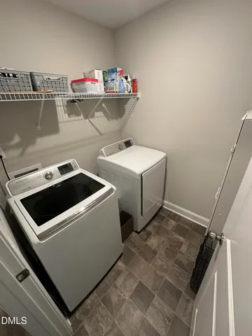 a view of house with a large window and potted plant
