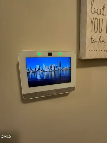a kitchen with stainless steel appliances a dining table chairs and wooden floor