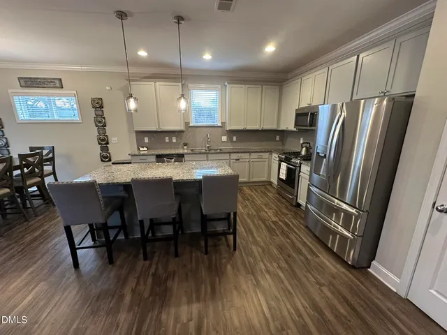 a view of a house with many windows next to a road