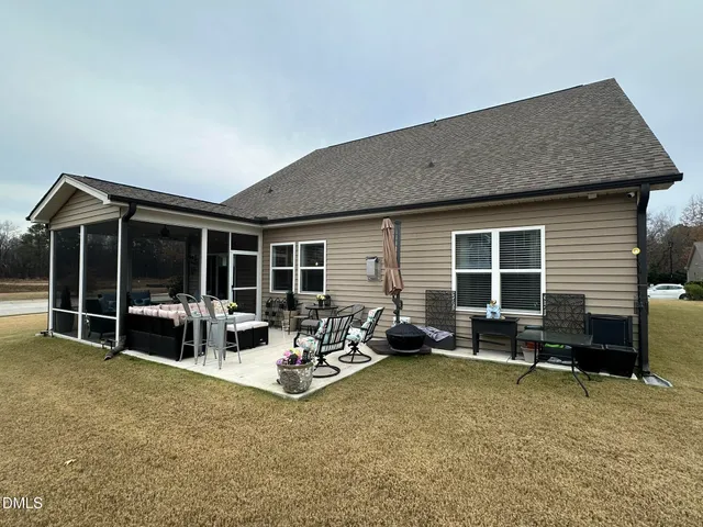 a backyard of a house with plants and outdoor seating