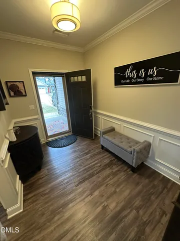 a view of a room with wooden floor and window