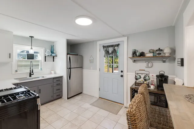 a kitchen with a sink stove and refrigerator