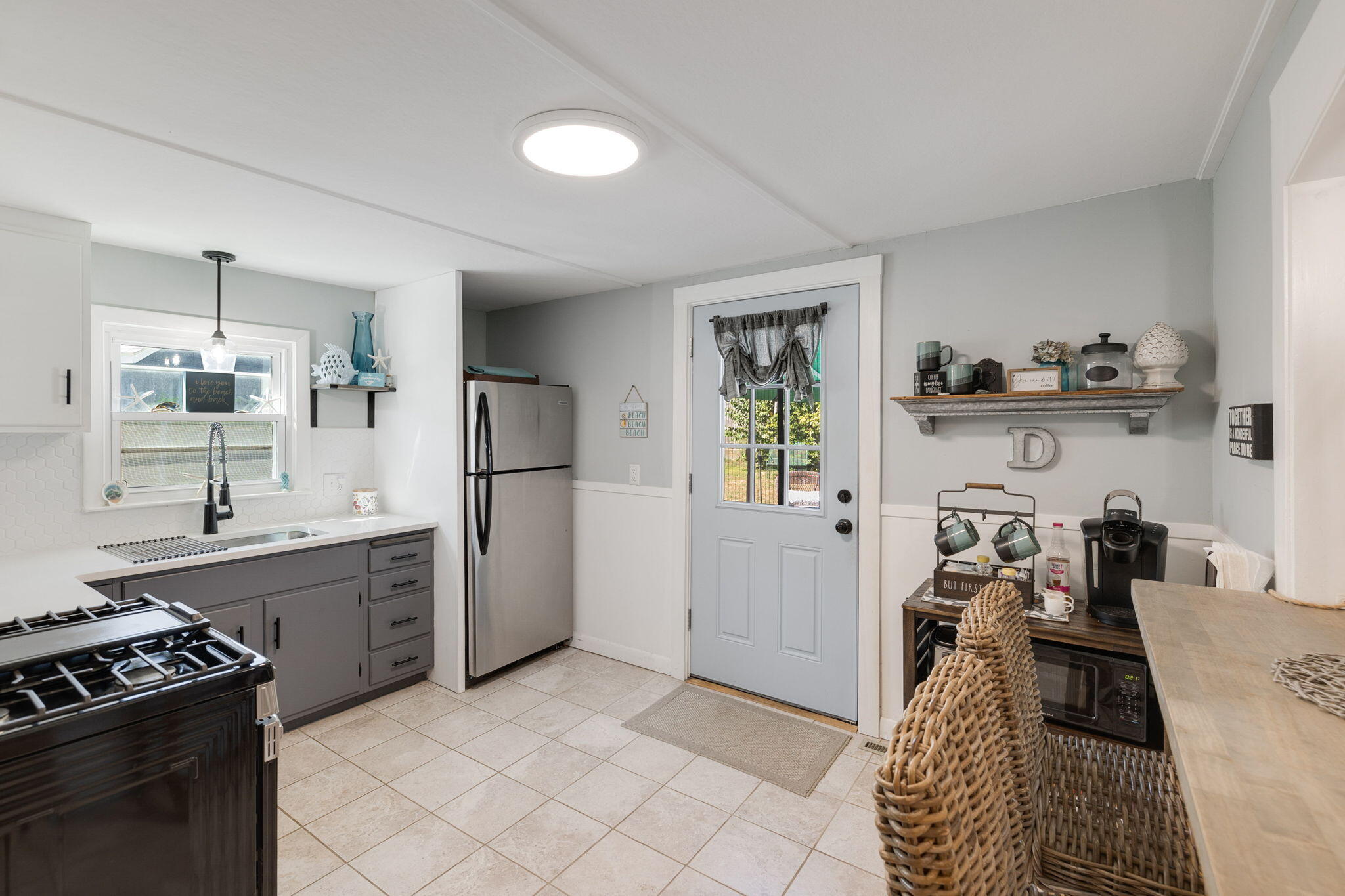 24 Butler Street Buzzards Bay, MA 02532 - Photo 12 of 37 a kitchen with a sink stove and refrigerator