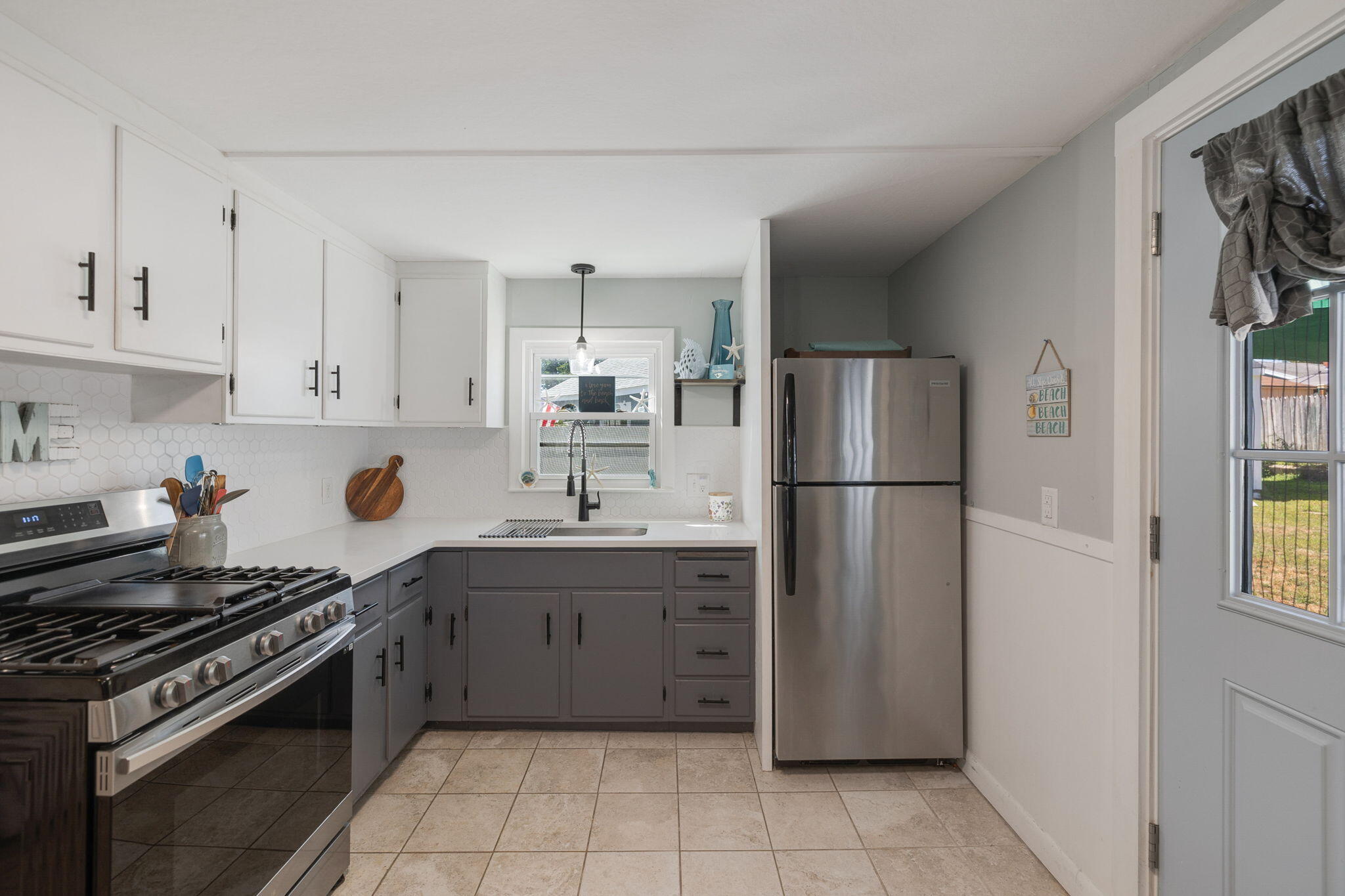 24 Butler Street Buzzards Bay, MA 02532 - Photo 13 of 37 a kitchen with a refrigerator and a sink