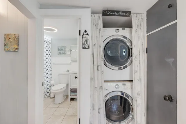 a utility room with sink dryer and washer
