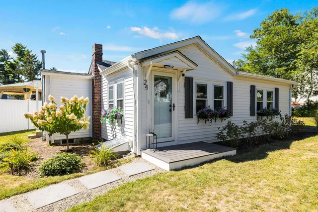 a front view of a house with garden