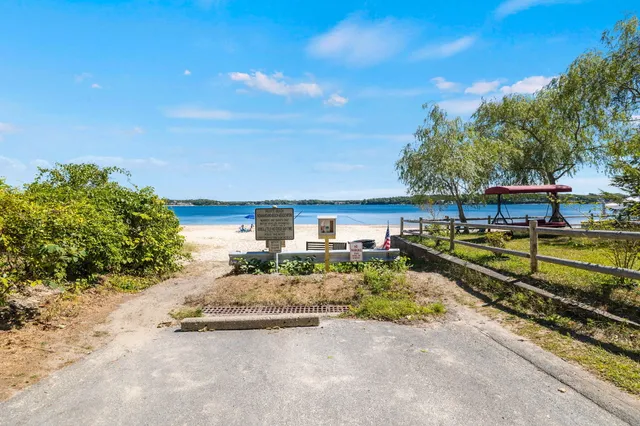a view of a yard with wooden fence