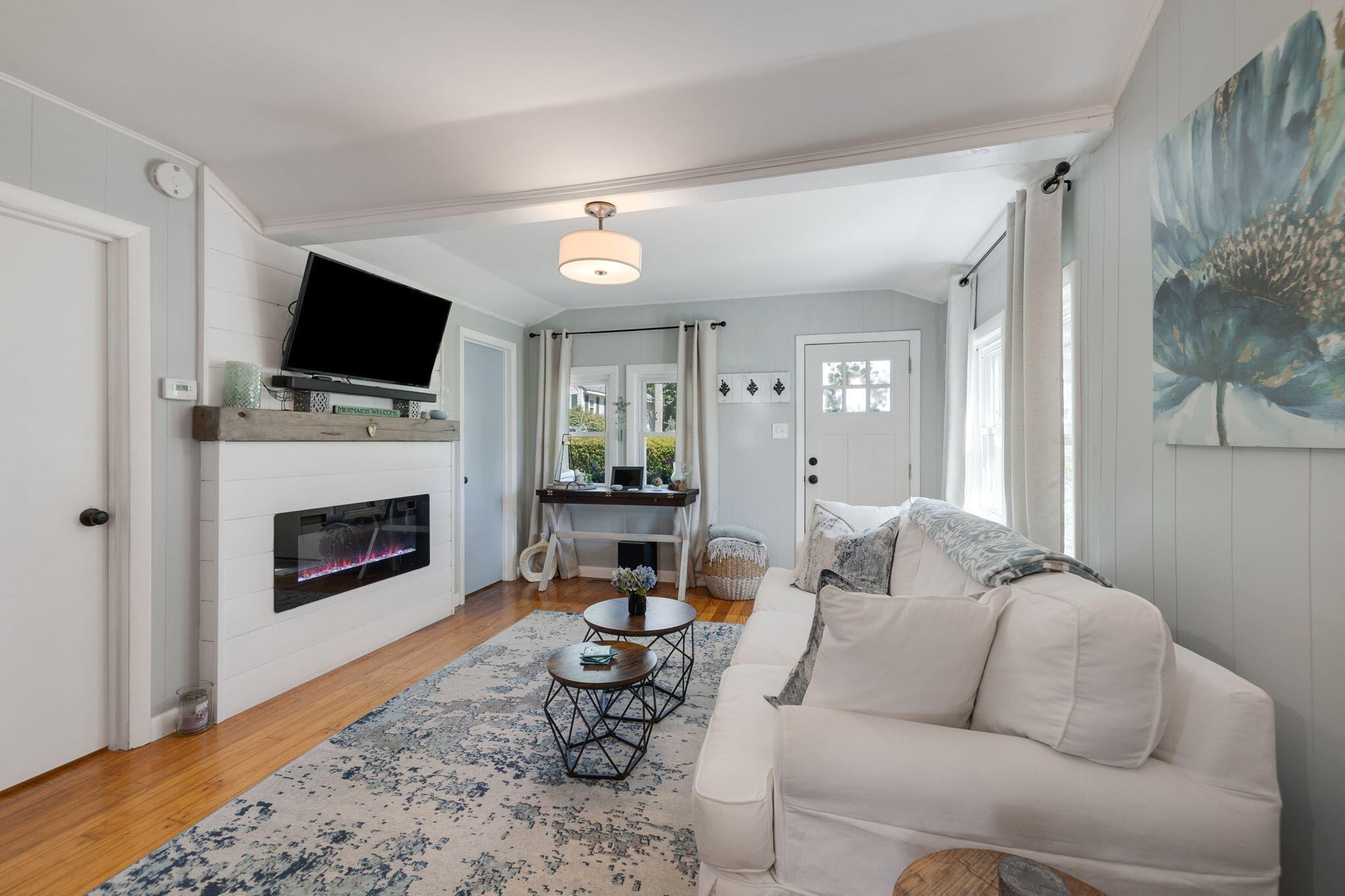 24 Butler Street Buzzards Bay, MA 02532 - Photo 3 of 37 a living room with furniture a fireplace and a flat screen tv