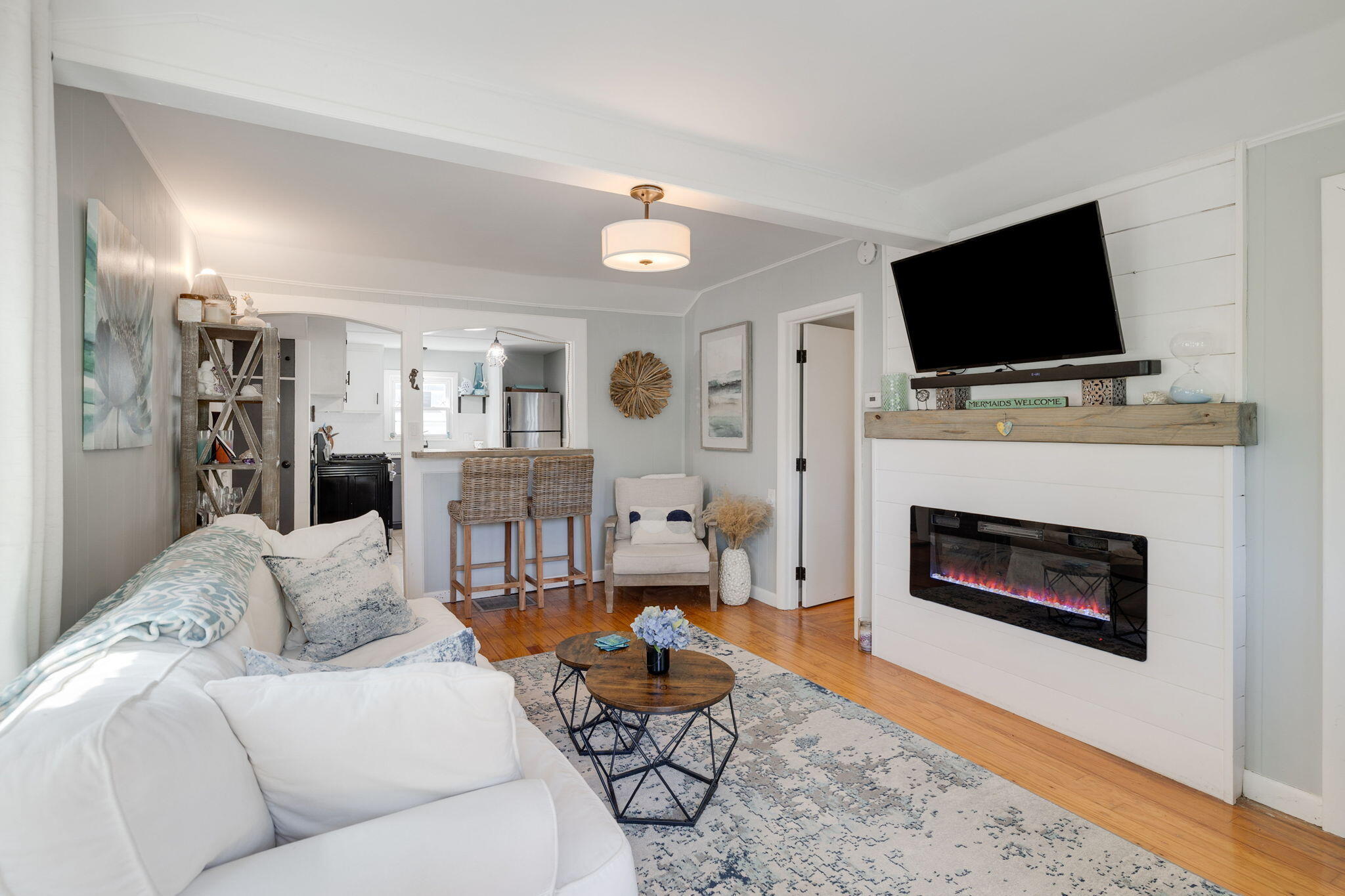 24 Butler Street Buzzards Bay, MA 02532 - Photo 4 of 37 a living room with furniture a flat screen tv and a fireplace