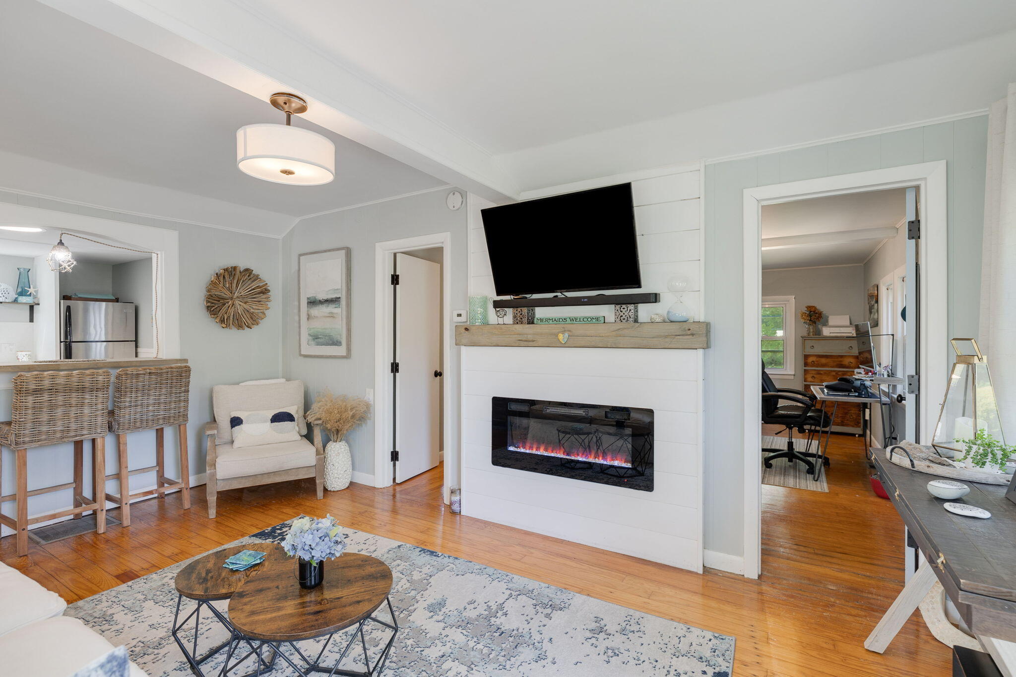 24 Butler Street Buzzards Bay, MA 02532 - Photo 5 of 37 a living room with furniture a flat screen tv and a fireplace