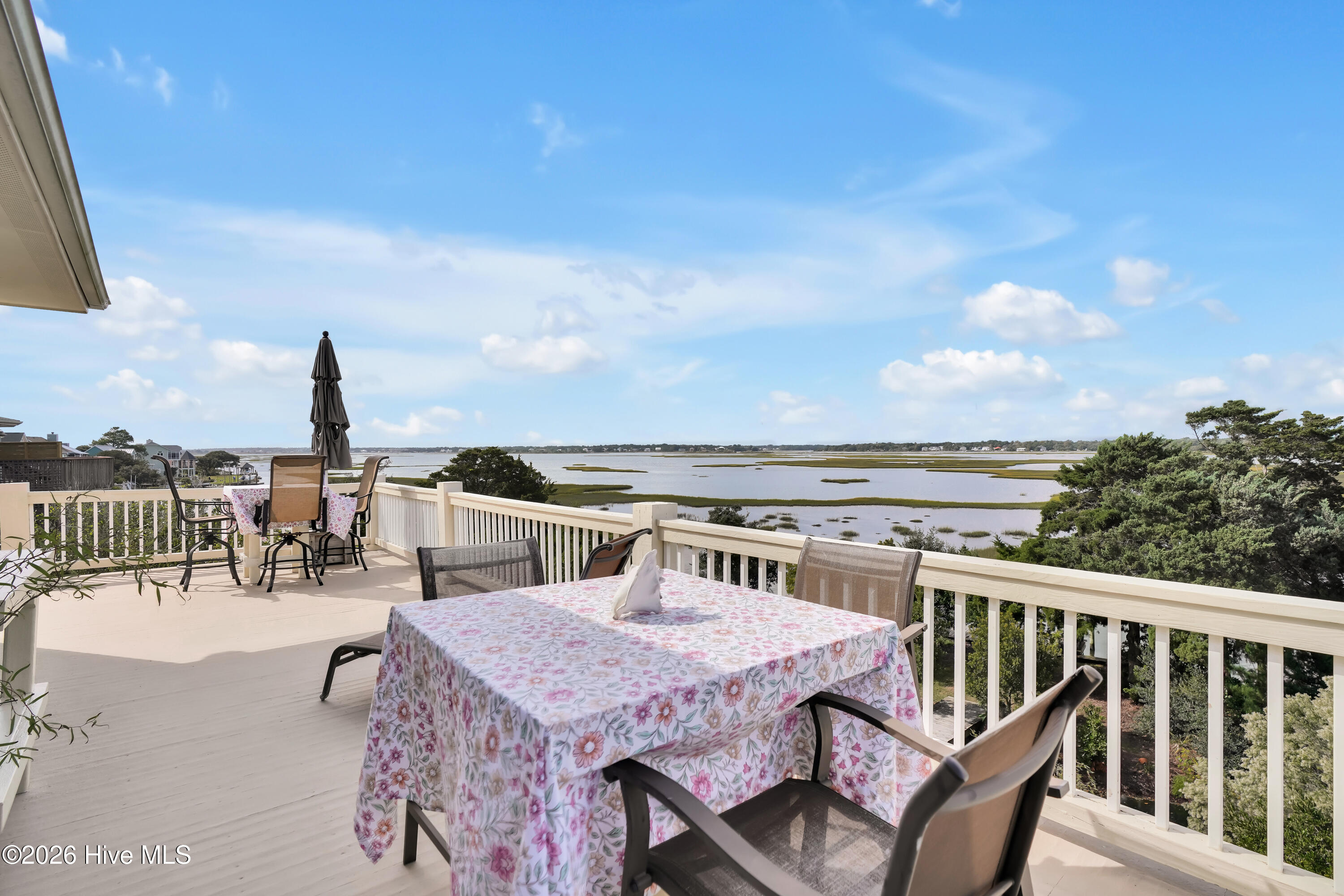 10 W Ridge Surf City, NC 28445 - Photo 32 of 86 outdoor dining and view from master bedroom entrance to balcony