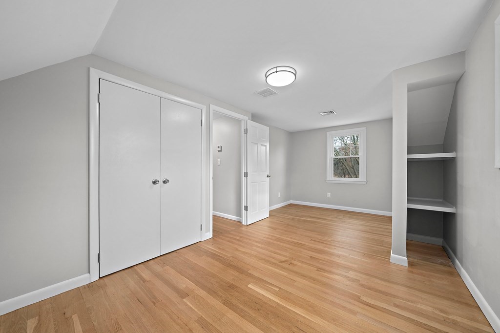 14 Curtis Road Canton, MA 02021 - Photo 16 of 23 a view of an empty room with wooden floor and a window